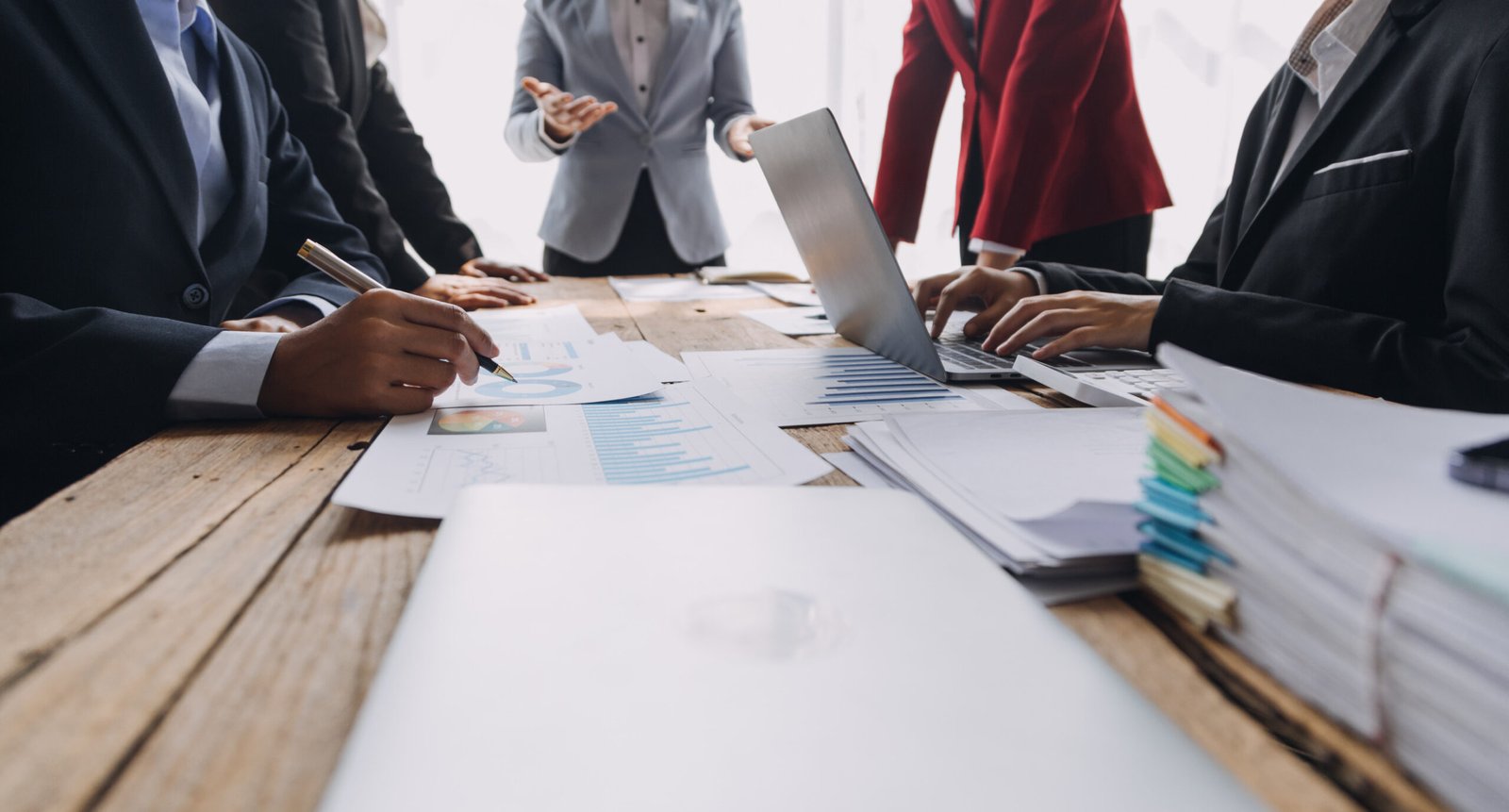 Financial analysts analyze business financial reports on a digit