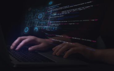 Hacker working with laptop at table, closeup. Cyber attack