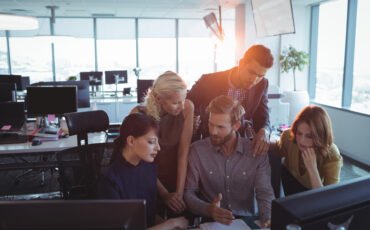 Business colleagues discussing together in office