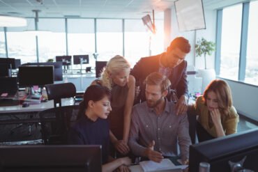 Business colleagues discussing together in office