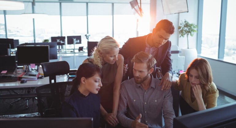 Business colleagues discussing together in office