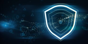 Creative wide perspective glowing shield hologram on blue wallpaper with various blurry icons. Cyber security, data protection concept. Modern wireframe design. 3D Rendering.