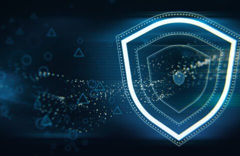 Creative wide perspective glowing shield hologram on blue wallpaper with various blurry icons. Cyber security, data protection concept. Modern wireframe design. 3D Rendering.