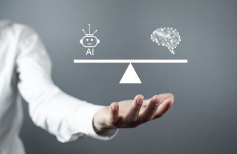 Man showing human brain with a Ai robot on scales.